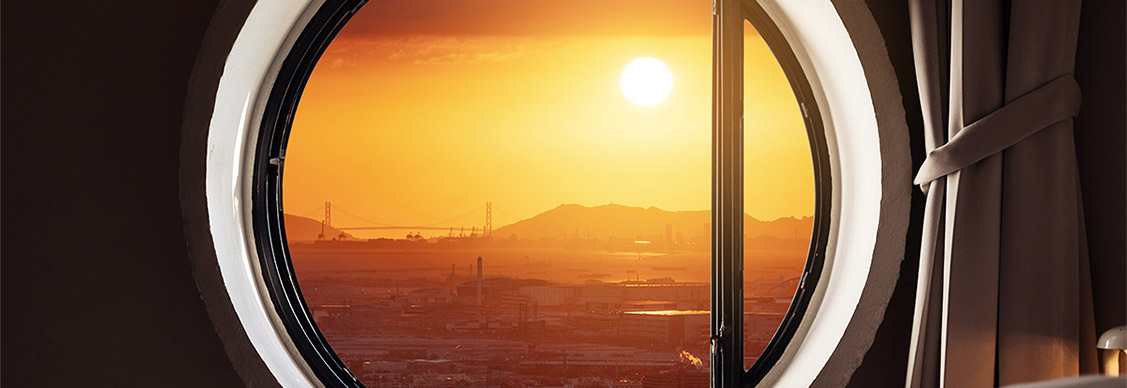 Looking through window, city view sunset with the sun in Japan