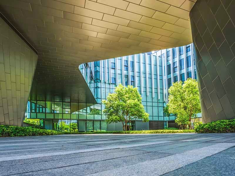 Glass building surrounded wit trees