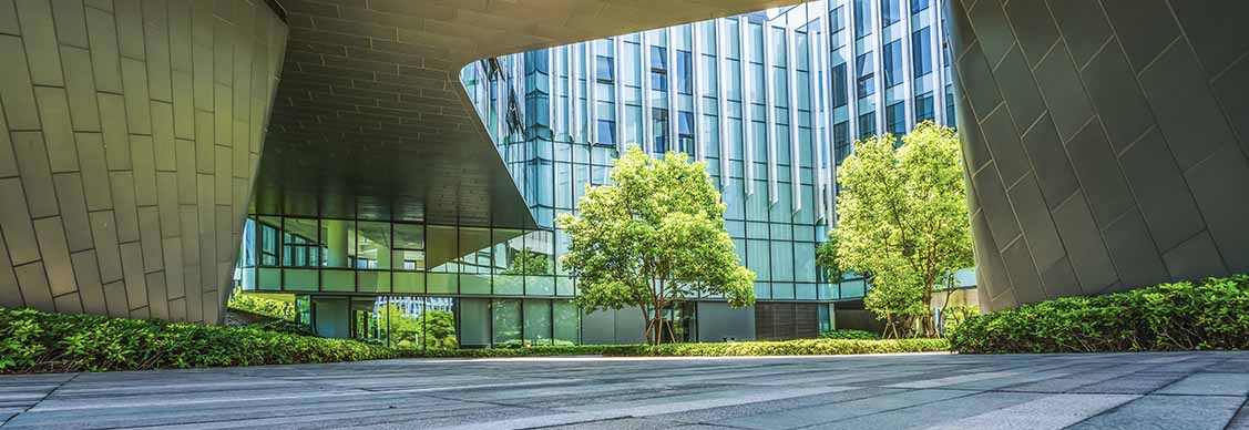 Glass building surrounded wit trees
