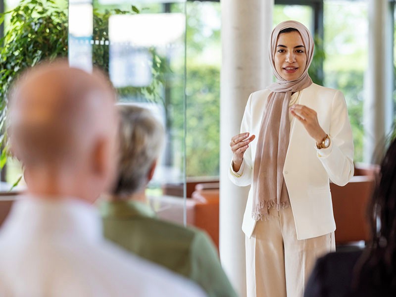 Young middle eastern businesswoman giving a speech in a business seminar.
