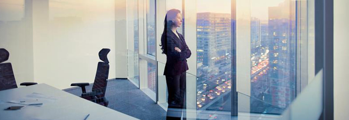 A woman in the office looking outside of the window