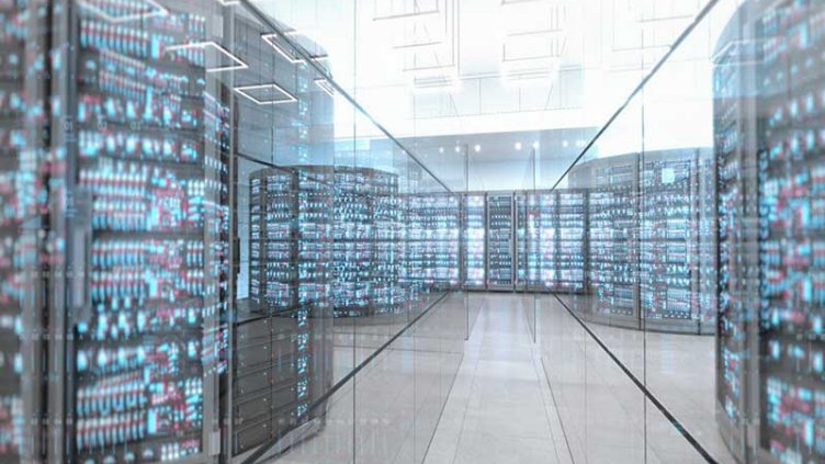 Data center server room in a large illuminated space with glass walls