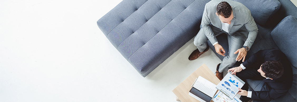 Two business man discussing work on table in office, top view