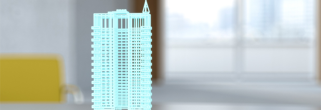 Hologram of building on digital tablet on desk