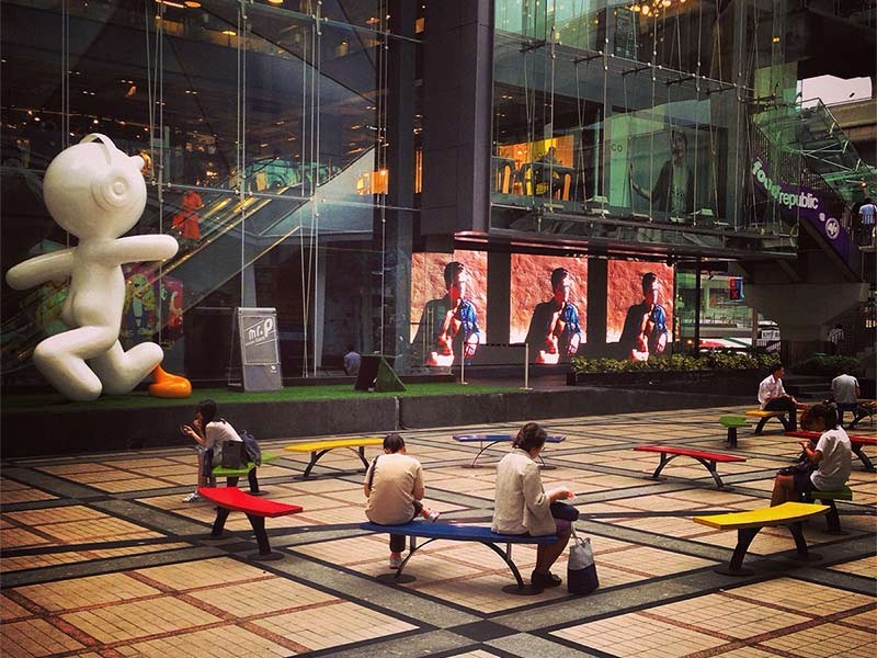 People sitting outside shopping mall