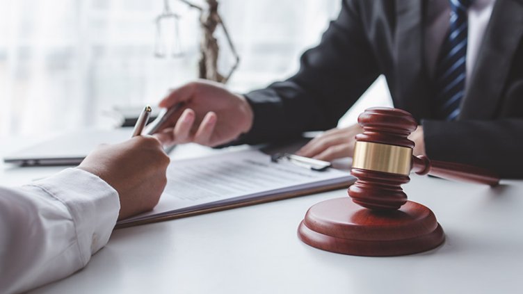 Cropped view of hands and paperwork on the desk