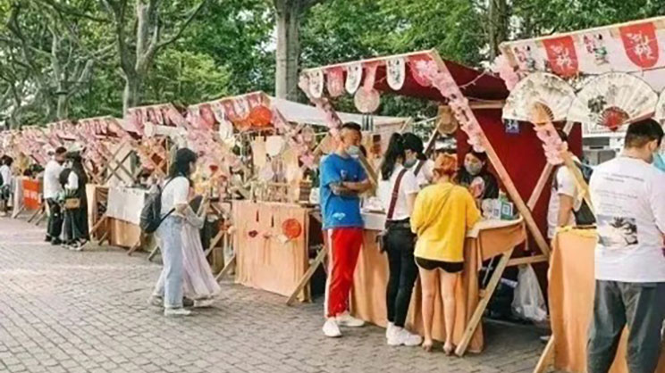 crowd on a street stalls