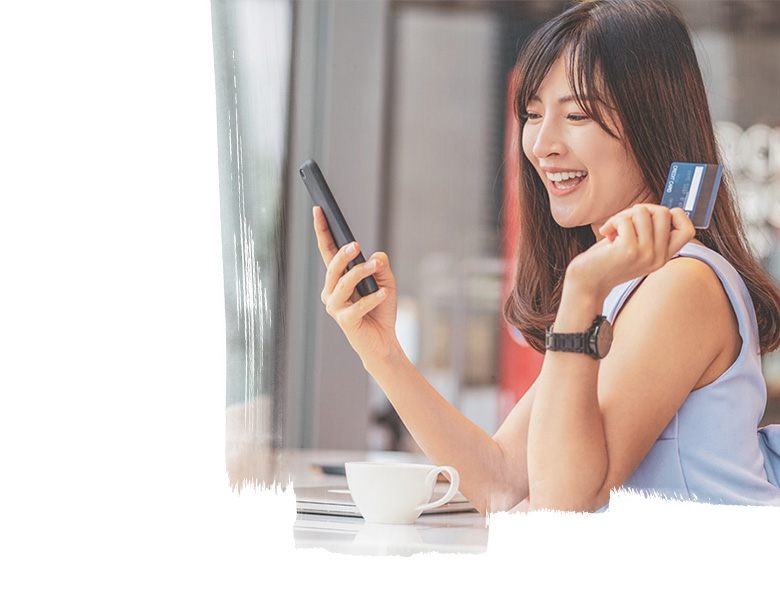 A girl holding a phone and card