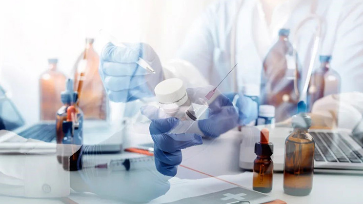 lab technician holding a syringe and medicines