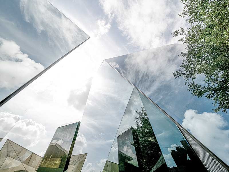 Glass building wit clouds at the background