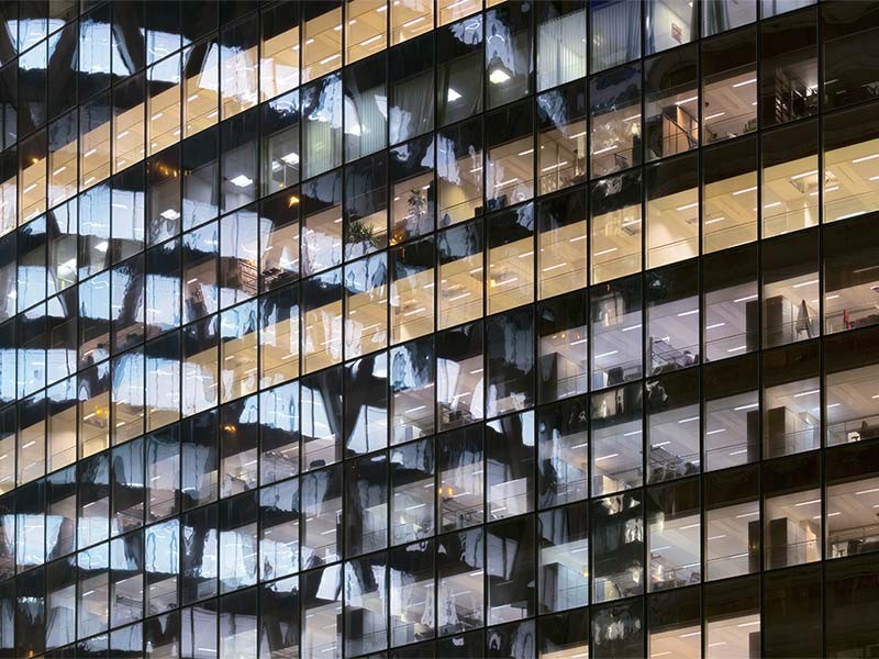 Photo of an office building with lights on at night