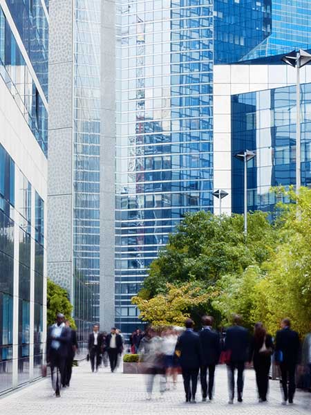  Numerous professional walking infront of buildings