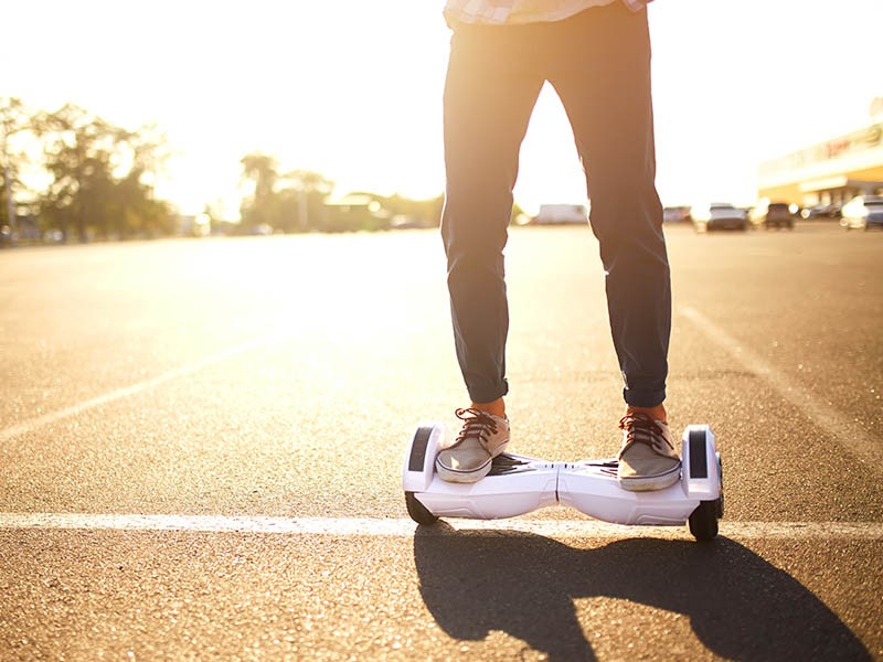 Young man riding on the hoverboard