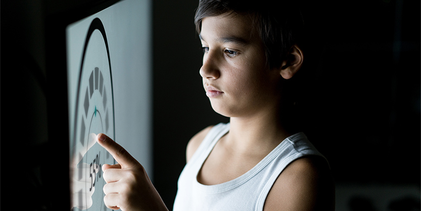 Person using large touch screen with digitally generated images and icons for smart home