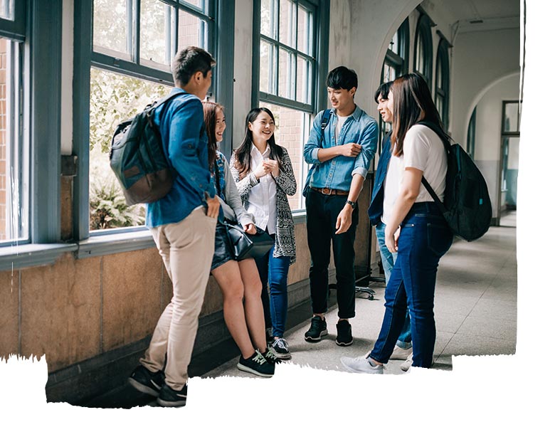 students standing in a hallway and talking to each other