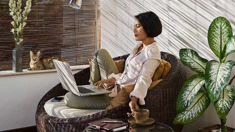 women working on laptop at her residence