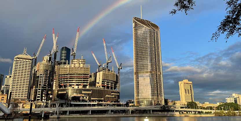 Building near to lake with rainbow behind
