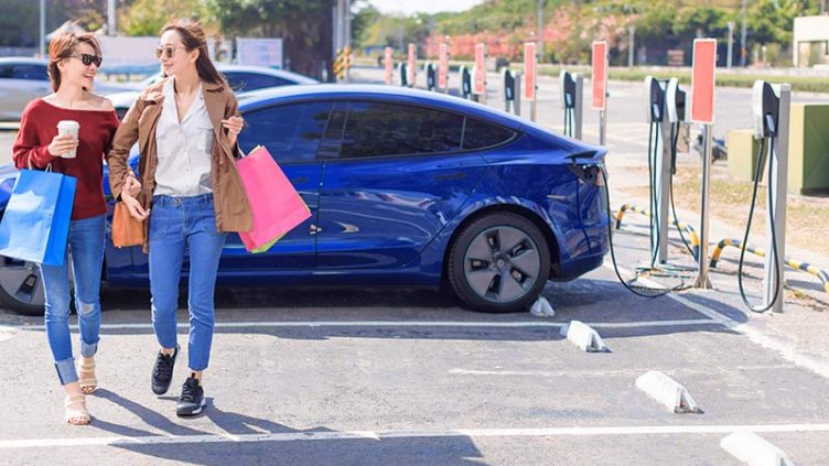 two women in Tesla charging station