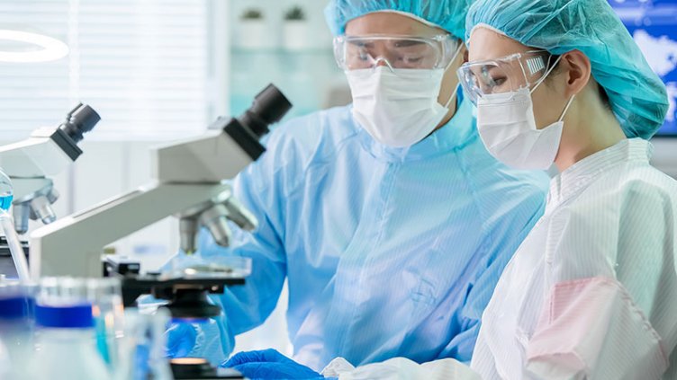 Asian scientist use microscope