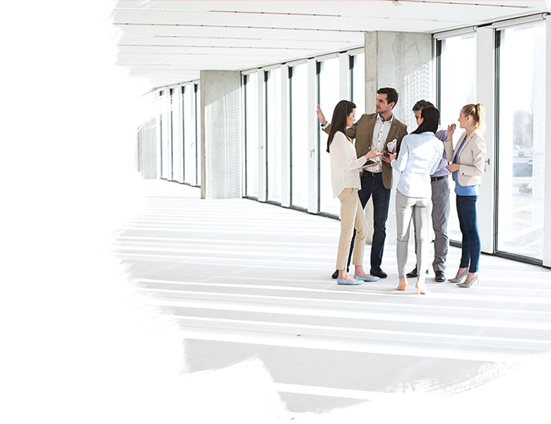 Full length of business people having discussion in empty office space