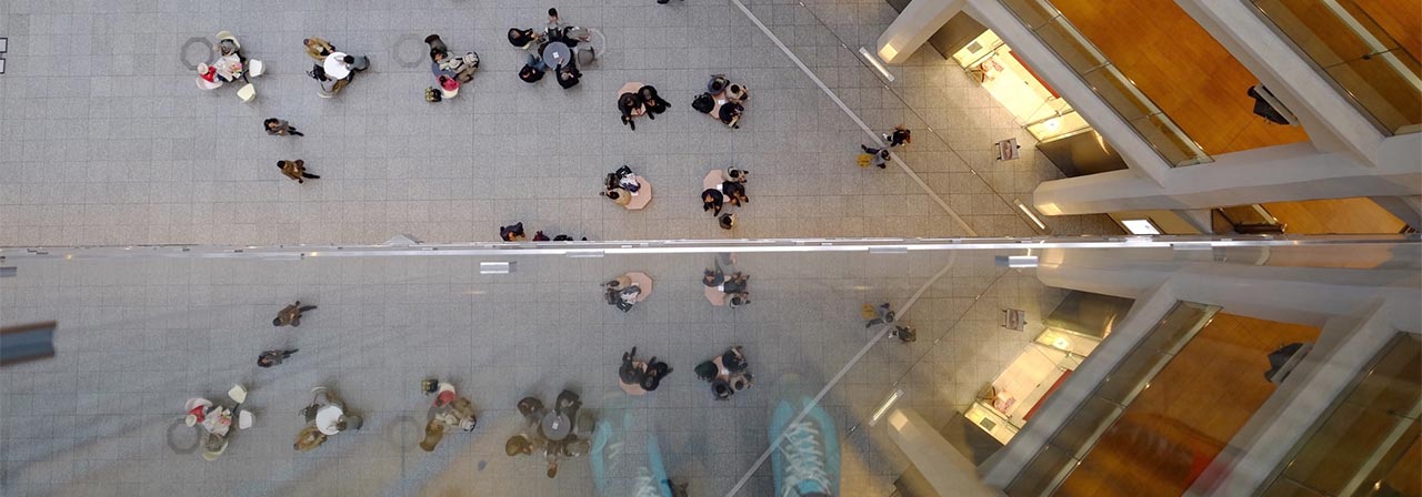 Bird’s eye view of building and people sitting around tables