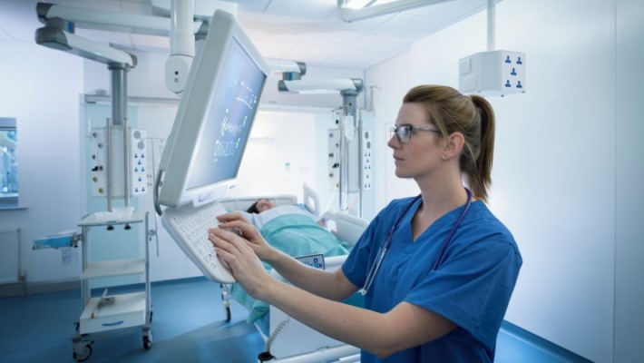 A nurse is operating a machine