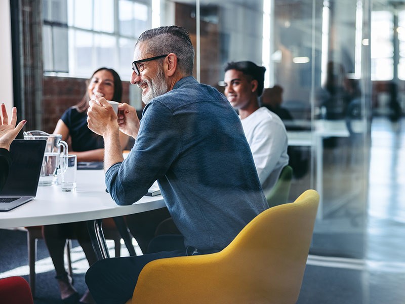 Small team meeting at table in office