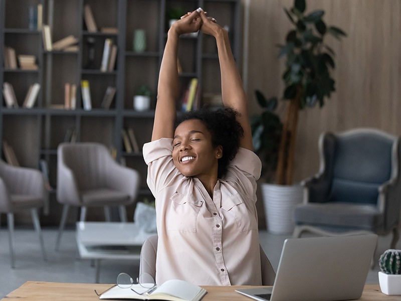 Woman stretching in a office