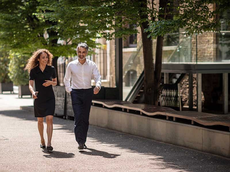 A man and woman walking and smiling