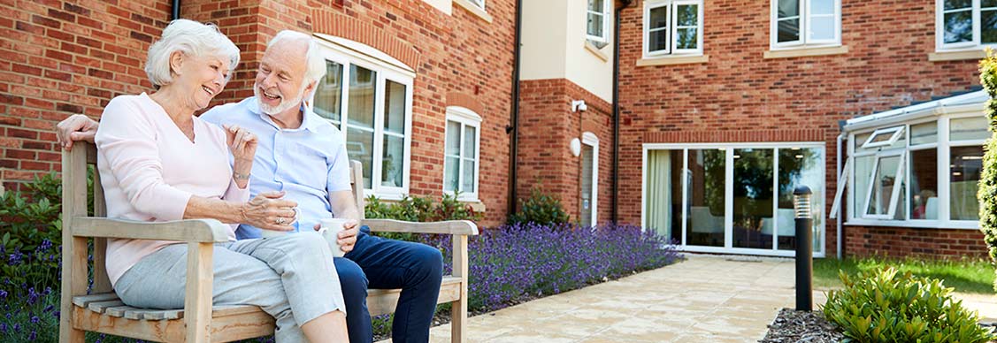 A couple sitting on bench